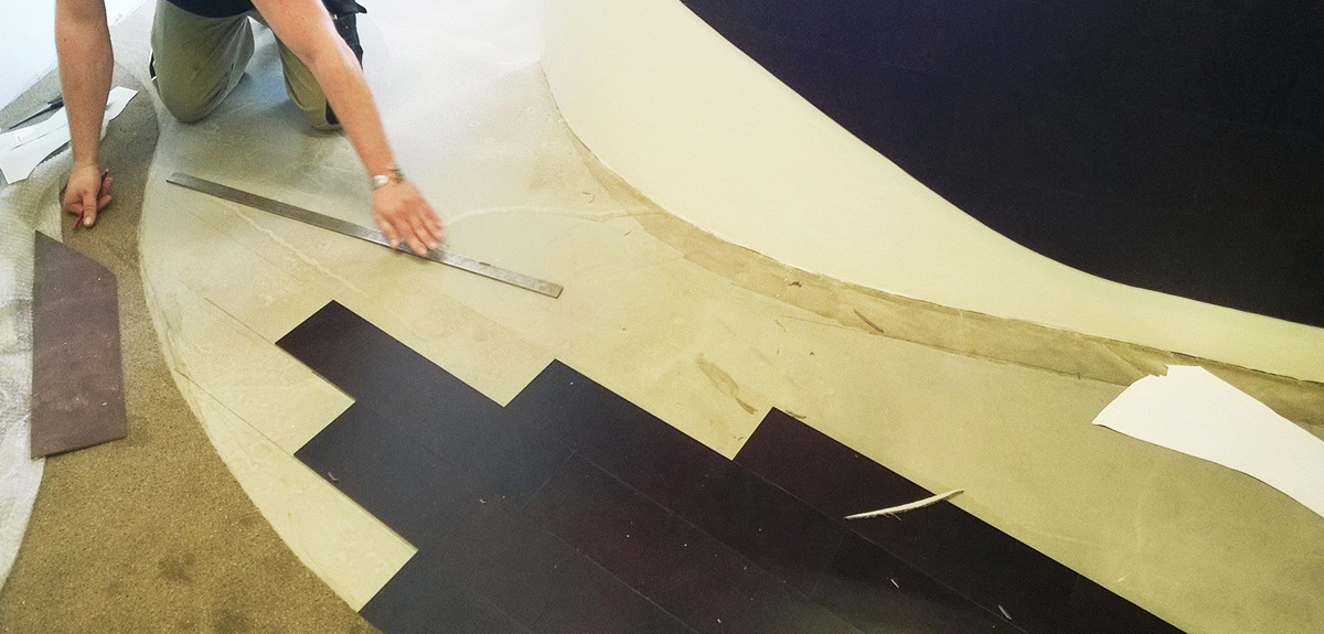 Handcrafted leather flooring manufacture. Counter and floor are covered in leather.